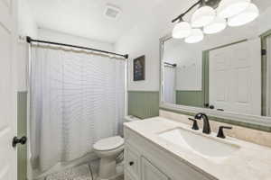 Bathroom featuring a vanity with a light-toned countertop, integrated sink, and matte black faucet