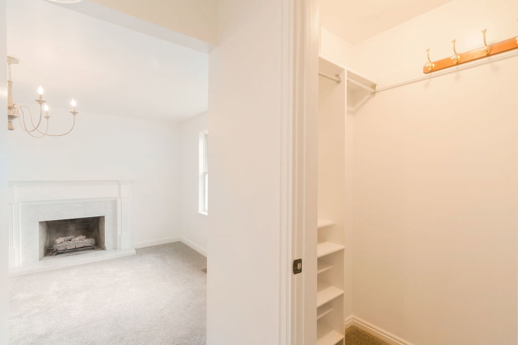 Functional closet featuring built-in shelving and hanging rods