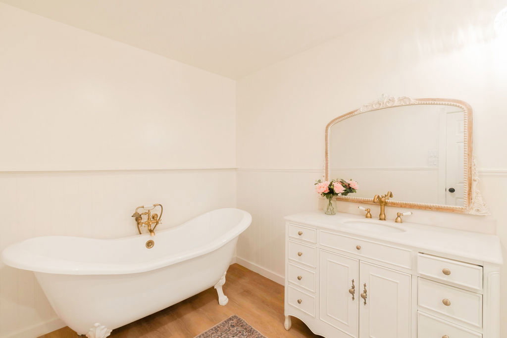 Freestanding clawfoot bathtub with brass fixtures