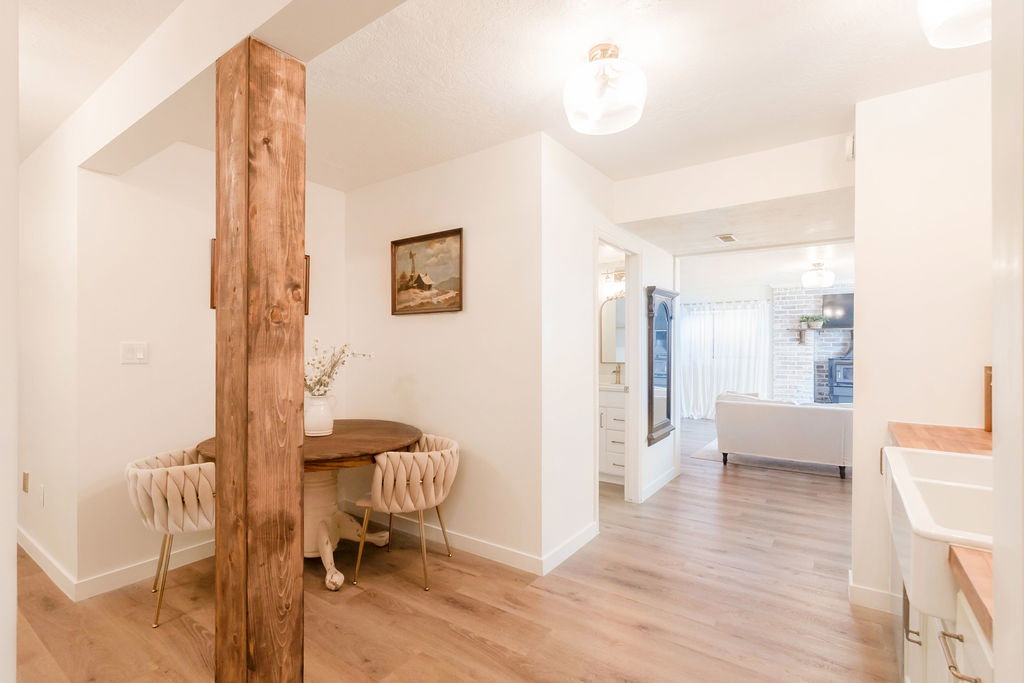 Warm wood beam accenting a bright interior with wood-finish flooring