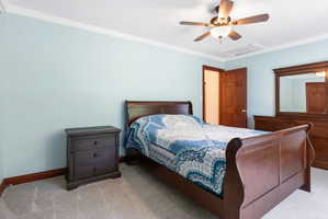 Bedroom 3 featuring light blue walls and crown molding