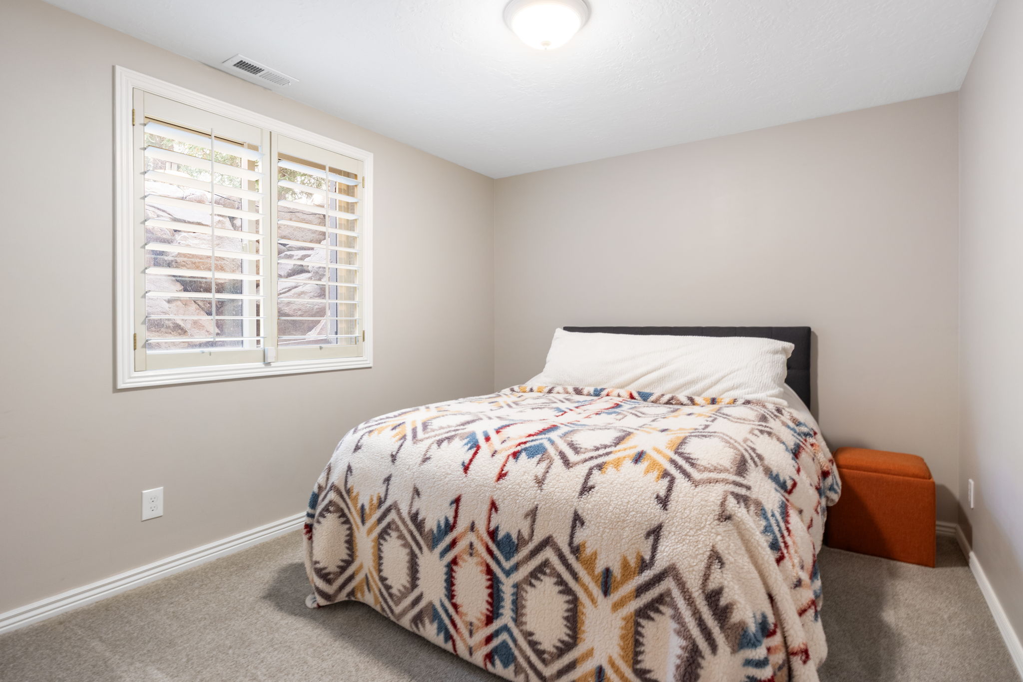 Recessed window featuring white plantation shutters