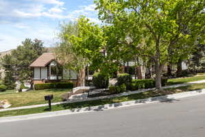 Traditional-style residence with a tiled roof, brick facade, and prominent bay windows