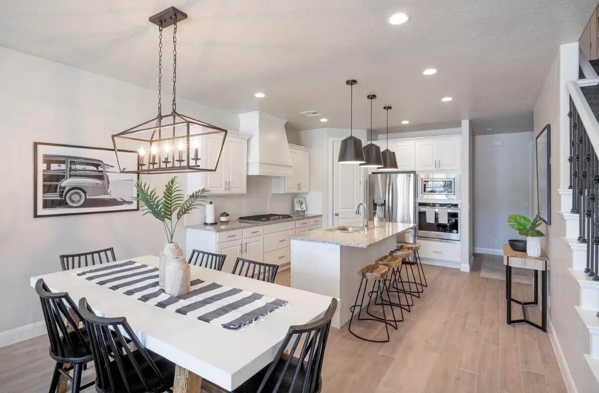 Open concept kitchen and dining area with wood-finish flooring