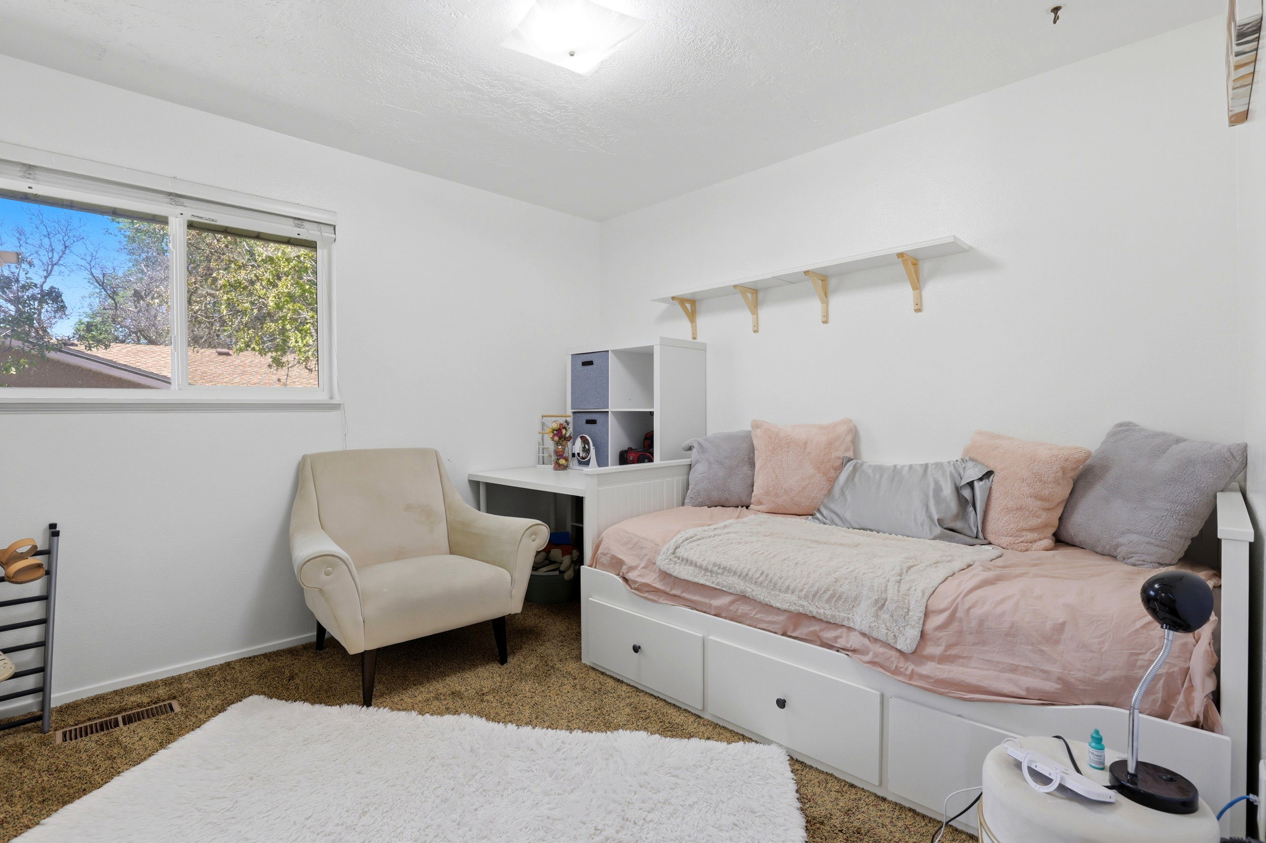 White walls with a light brown carpet