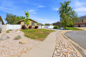 Ranch-style residence featuring a light-colored brick exterior, a driveway, and a two-car garage