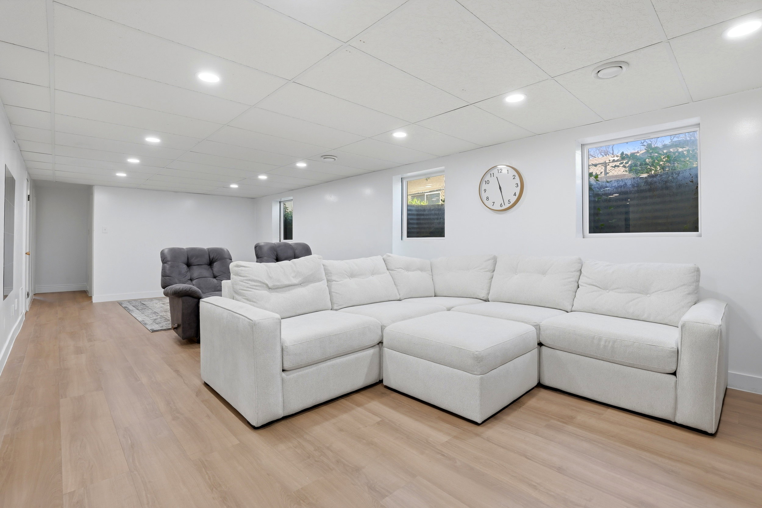 Spacious interior featuring light wood-finish flooring, recessed lighting, and crisp white walls
