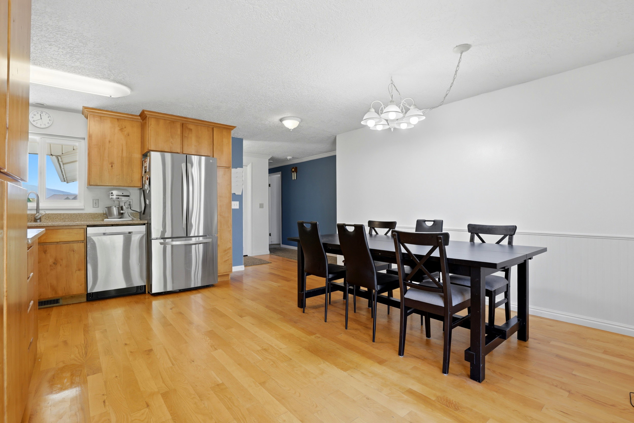 Open concept kitchen and dining area with wood-finish flooring