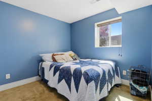 Bedroom featuring neutral carpet flooring and white baseboards