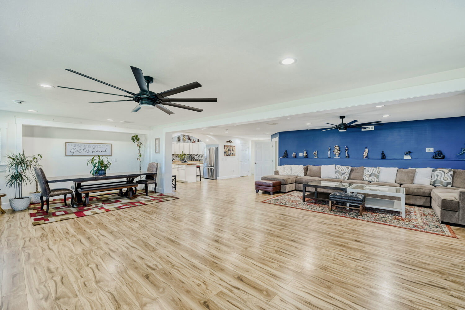 Open-concept living space featuring wood-finish flooring, recessed lighting, and dual ceiling fans