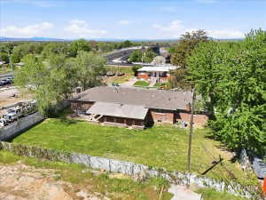Fully fenced home with a large grassy yard