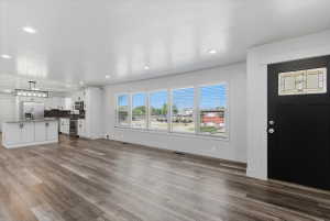 Open-concept living space featuring vinyl flooring, recessed lighting, and updated kitchen