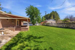 Expansive green lawn with a covered patio