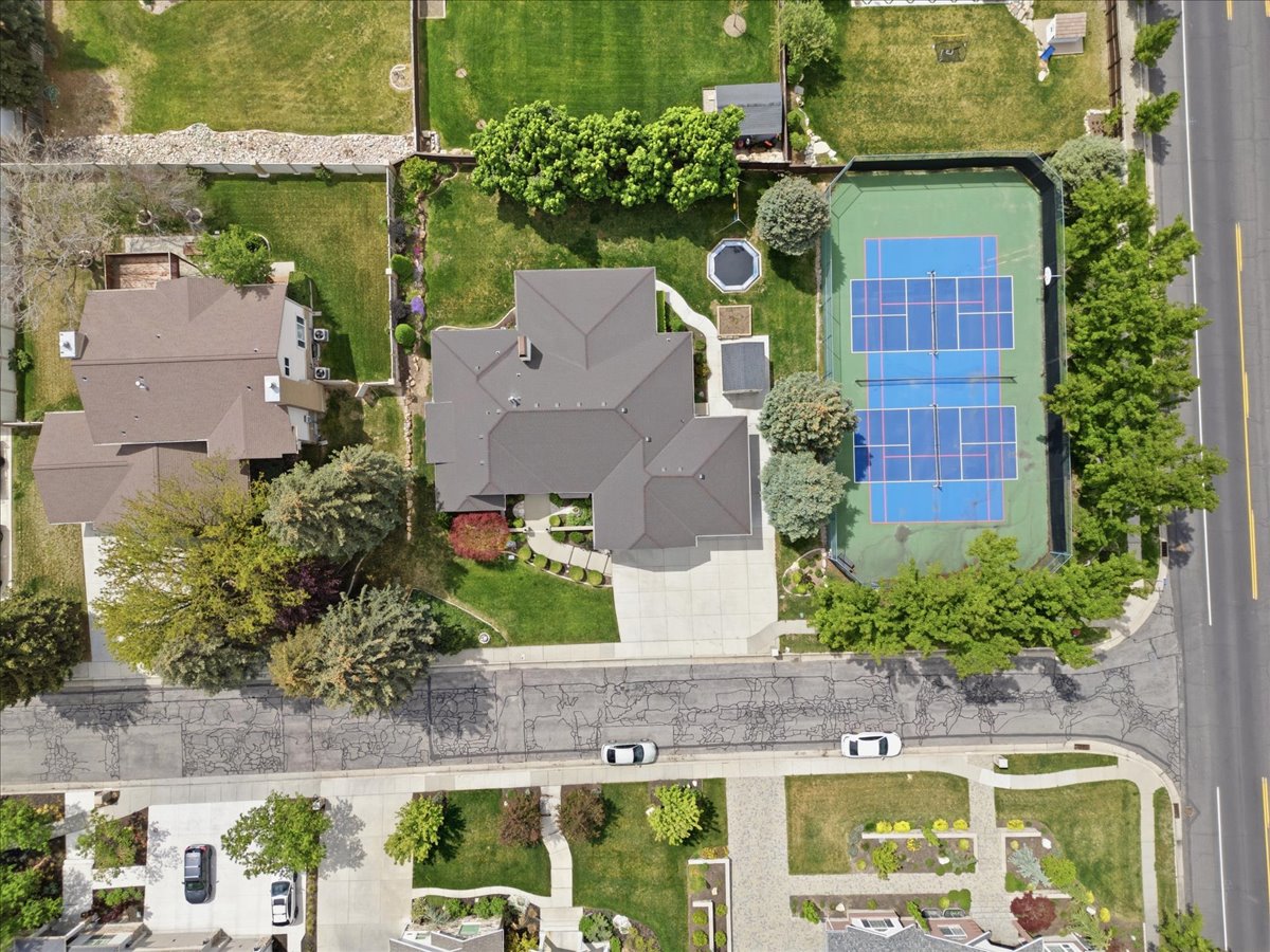 Expansive property featuring a large residence with a multi-gabled roofline and an attached concrete driveway
