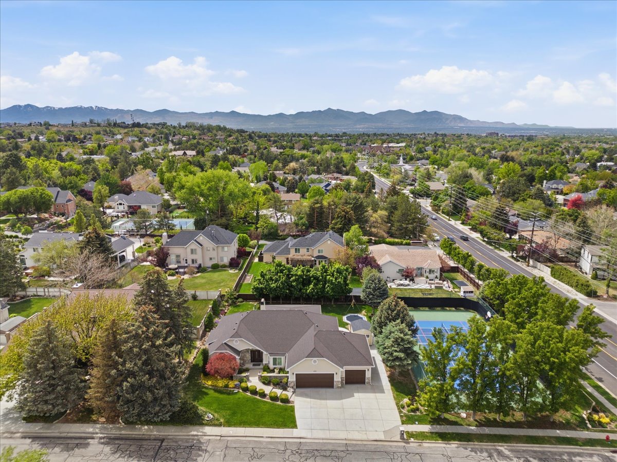 Spacious single-story residence with a multi-car garage, expansive driveway, and manicured landscaping