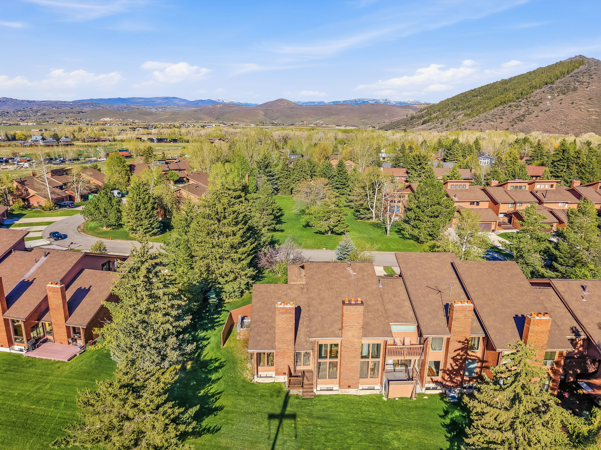 Townhome community with terracotta roofs and brick chimneys