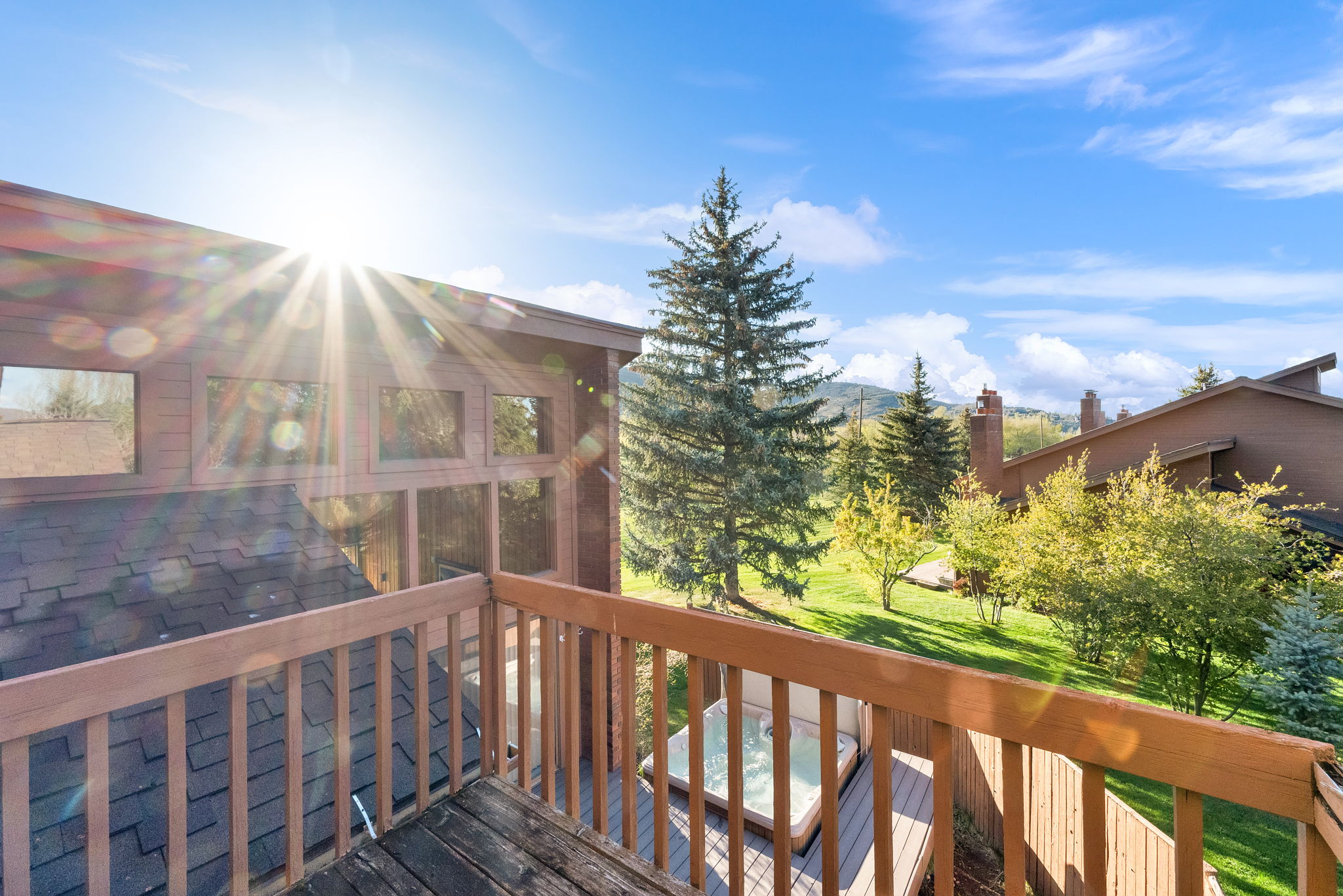 Upper-level balcony featuring wooden railings and decking