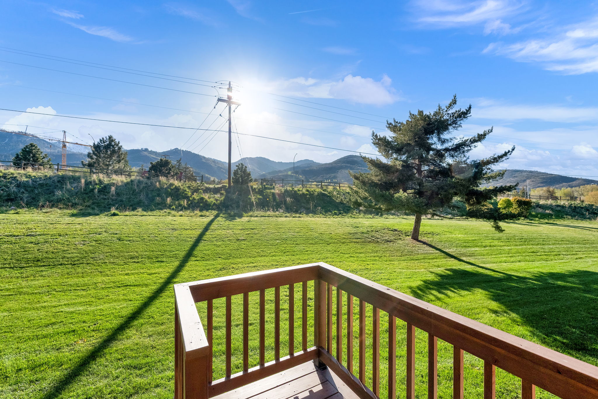 Expansive green lawn with mountain backdrop