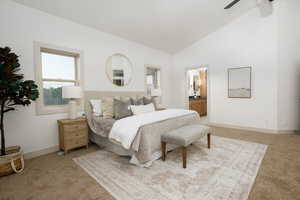 Vaulted ceilings enhance this spacious bedroom, featuring warm-toned carpet flooring and two windows with light-toned trim