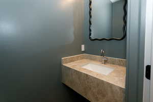 Floating vanity with an integrated rectangular sink and a single-handle faucet