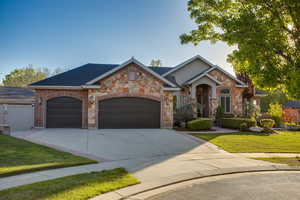 Stone and brick facade residence featuring an arched portico entry