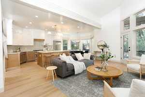 Open-concept living space featuring high ceilings and wood-finish flooring