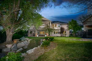 Expansive rear yard with a manicured lawn