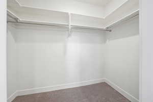 Spacious Primary Suite closet featuring white shelving
