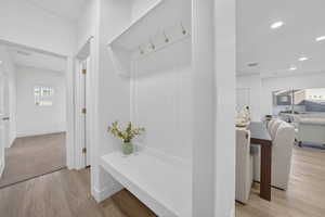Built-in entryway bench with beadboard detailing and brass hooks