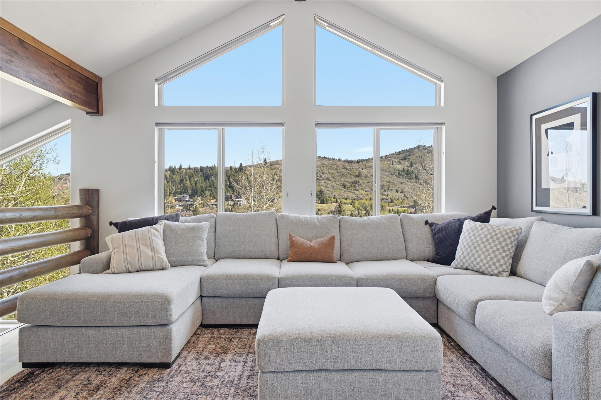 Vaulted ceiling living space featuring multiple windows
