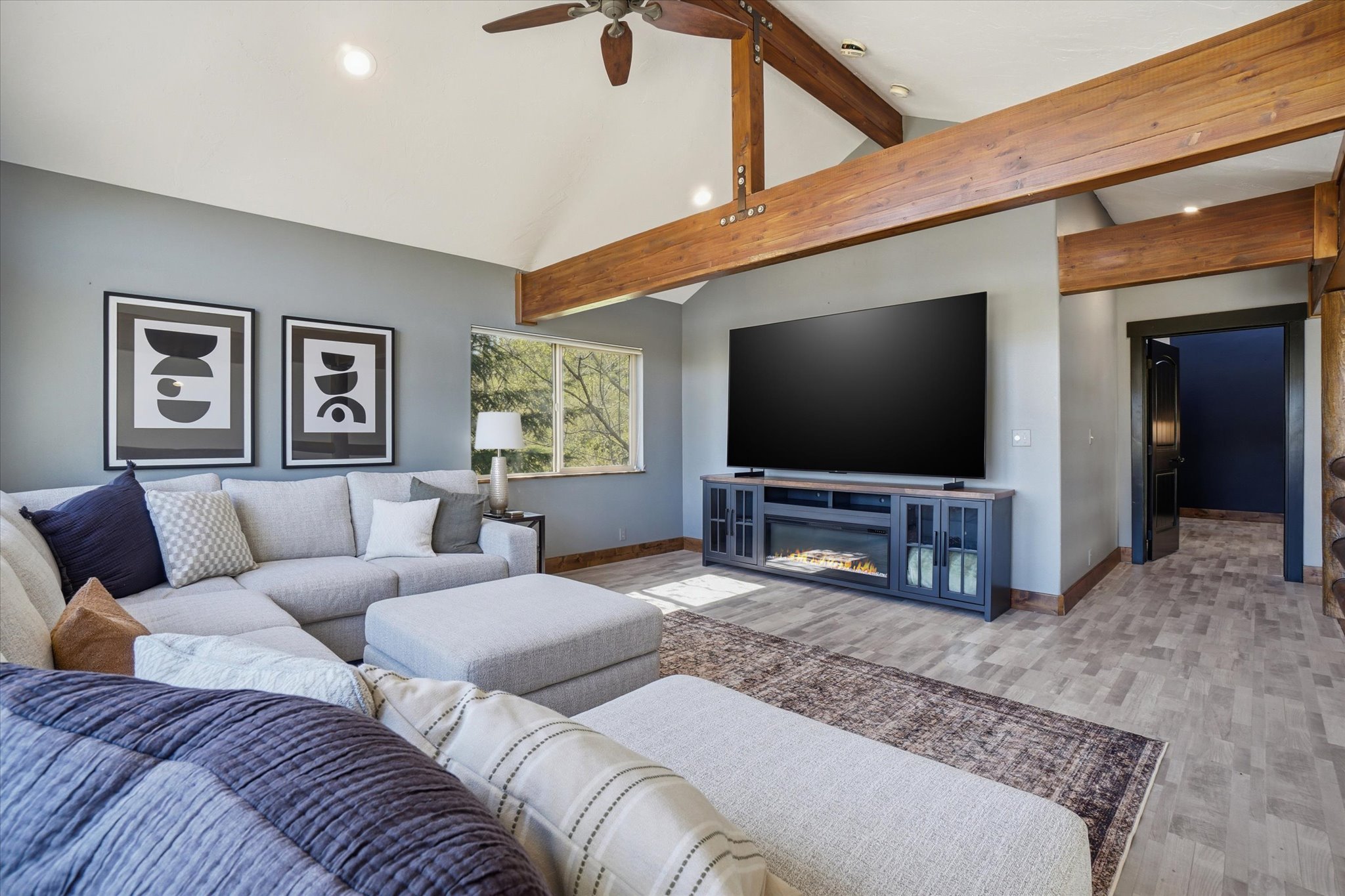 Vaulted ceiling with exposed wood beams, ceiling fan, and recessed lighting