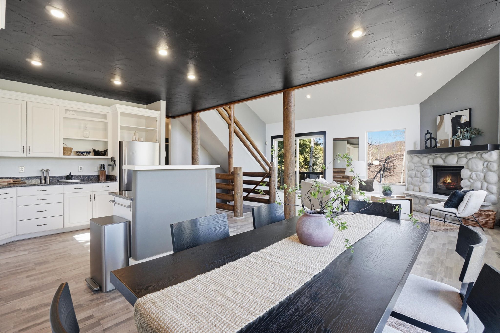 Open-concept living space with a kitchen, dining area, and living room