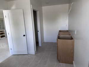 Modern interior featuring light gray rectangular floor tiles and a neutral wall paint palette