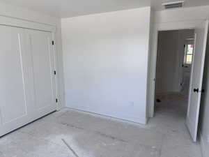 Unfinished room featuring white walls, white baseboards, and white trim throughout