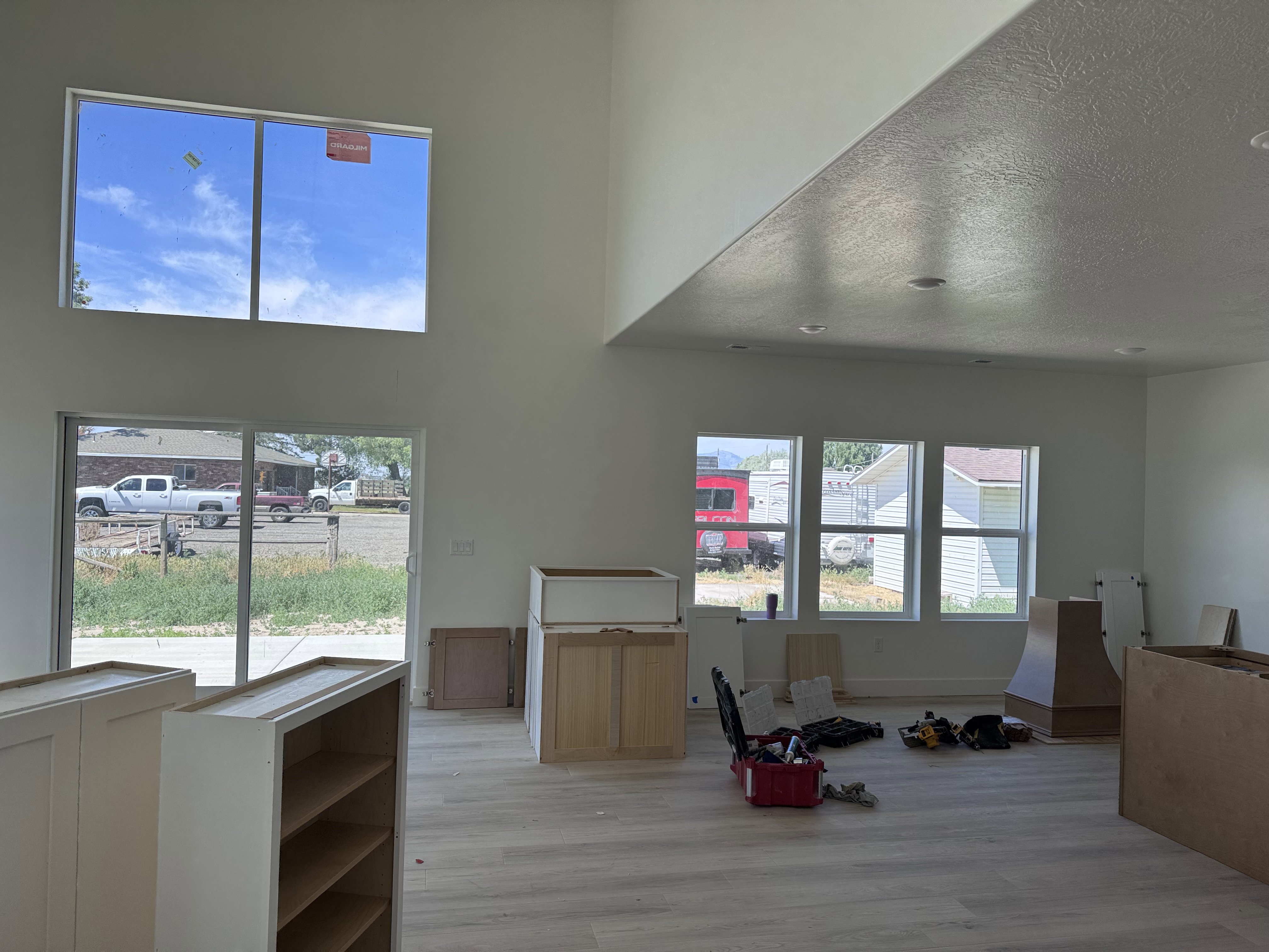 Spacious interior featuring a vaulted ceiling and contemporary light wood-finish flooring