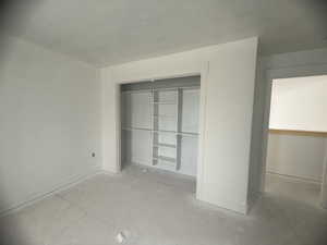 Spacious room featuring a built-in closet with shelving and hanging rods