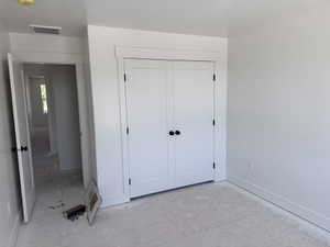 White bi-fold closet doors with matte black hardware, white baseboards, white door casings, and a white interior wall finish