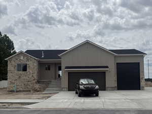 Contemporary exterior featuring a stone facade and beige vertical siding