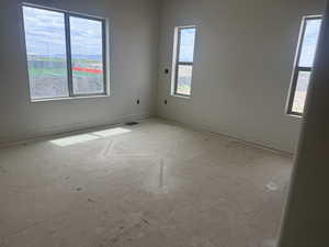 Spacious interior room featuring multiple windows, offering ample natural light