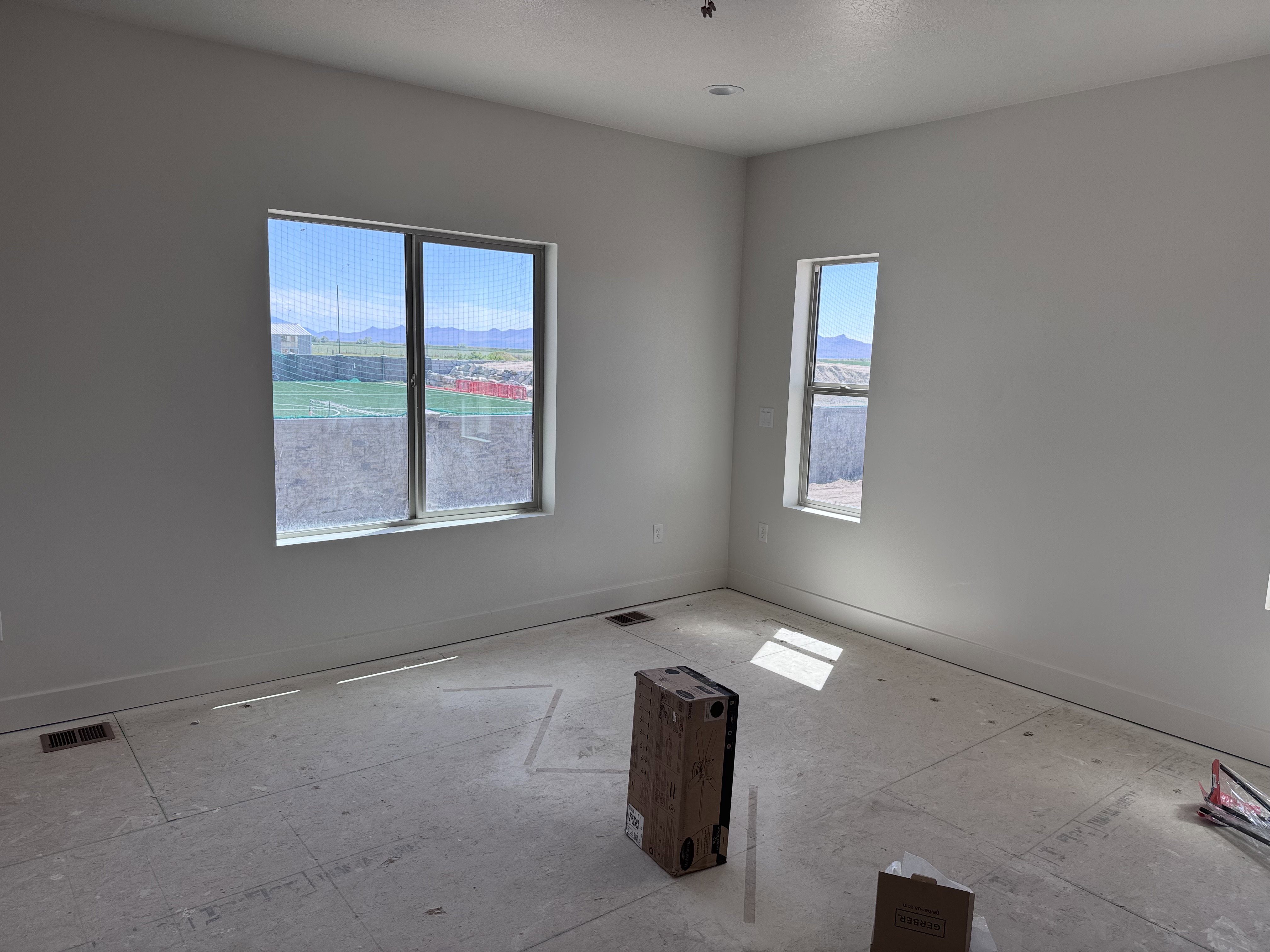Bright interior space featuring a large window and an additional vertical window