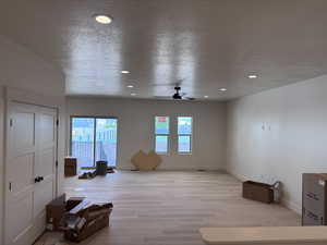 Spacious interior featuring wood-finish flooring and recessed lighting