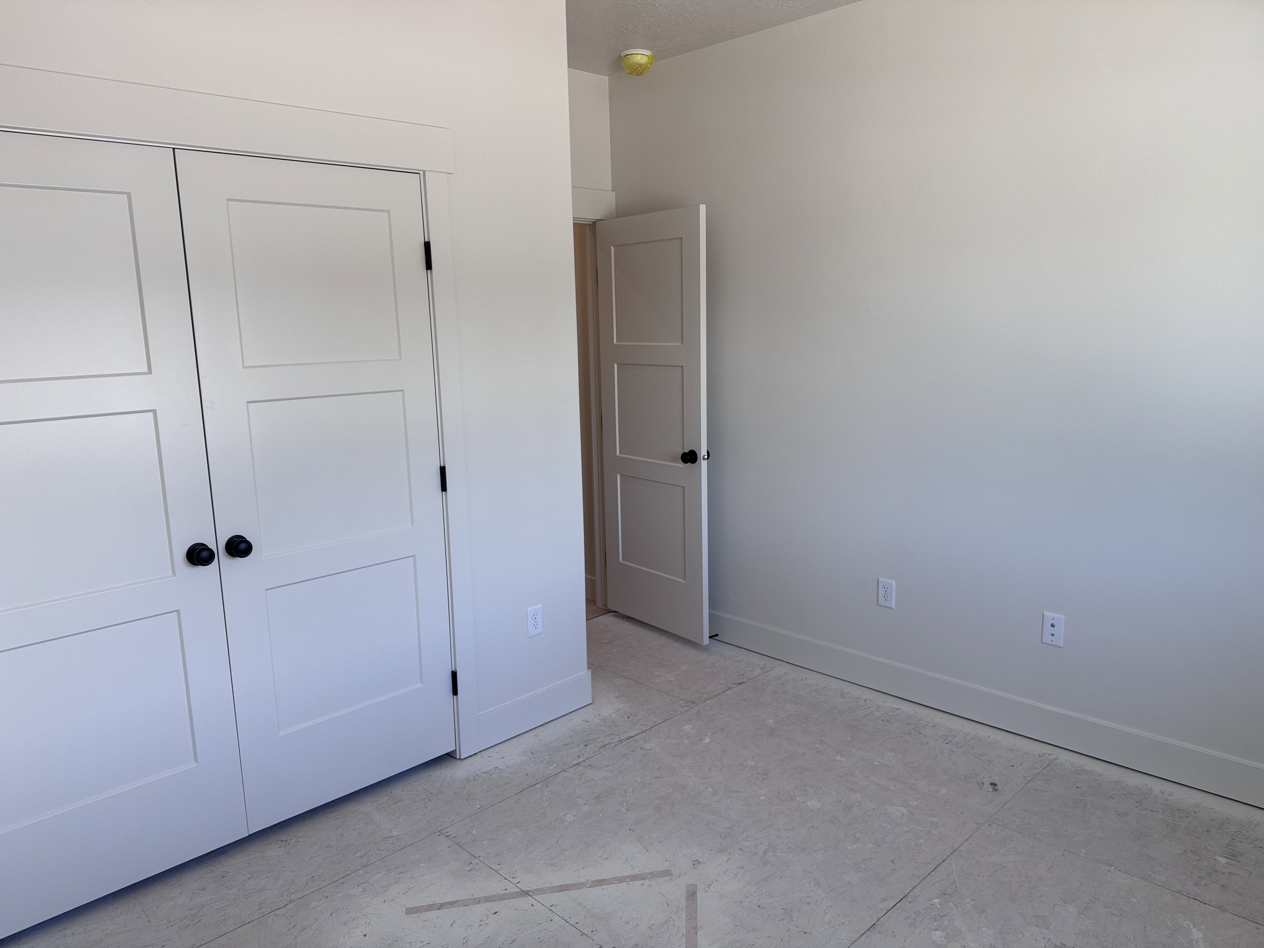 Room featuring neutral-toned walls, white trim, and light-colored flooring