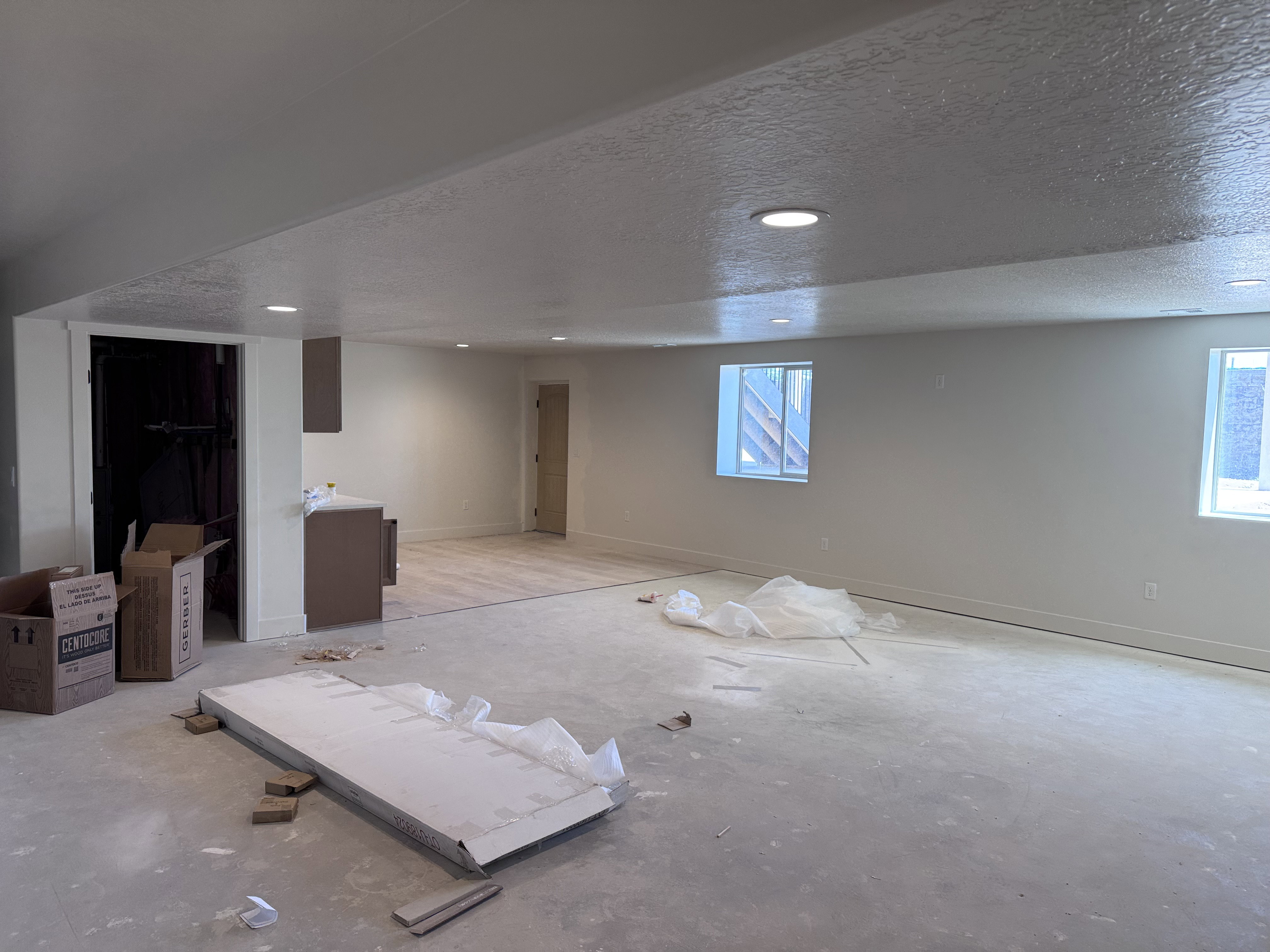 Spacious room with recessed lighting and two egress windows