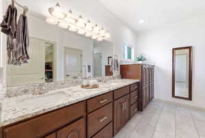 Dual vanity with granite countertops, undermount sinks, and chrome faucets