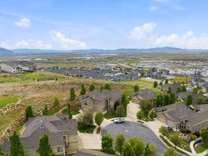 Aerial perspective showcasing a residential neighborhood with surrounding natural landscapes
