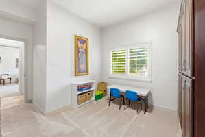 Room featuring neutral tone carpeting and white walls
