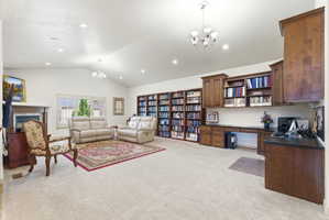 Spacious room featuring vaulted ceilings, recessed lighting, and light-toned carpeting