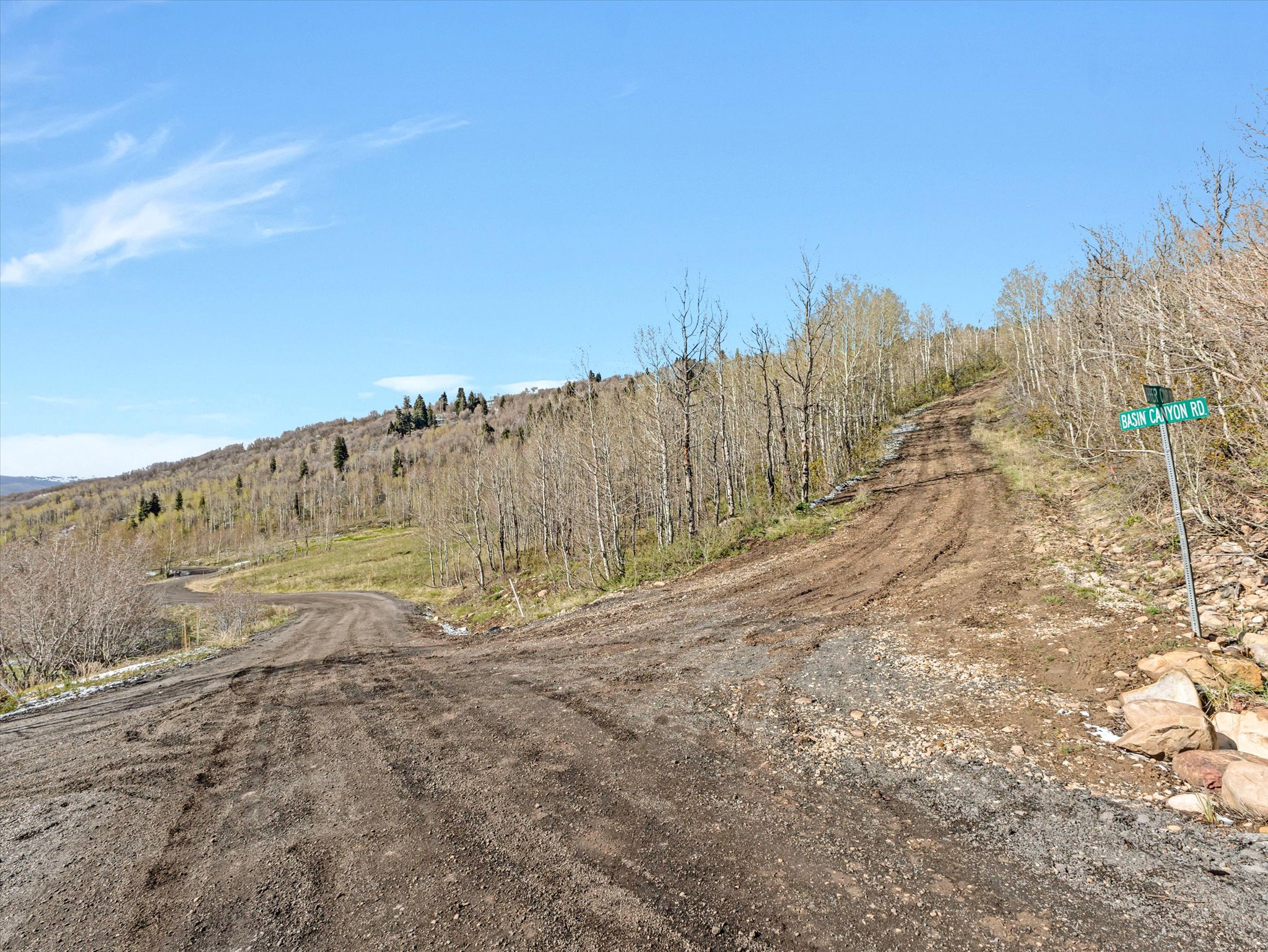 Dirt road intersection with a clear blue sky overhead
