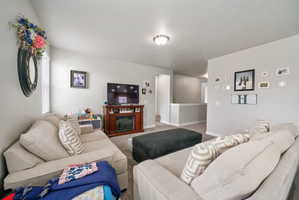 Spacious living area featuring light gray wall paint and recessed lighting