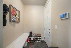 Entryway featuring a white paneled door, light neutral wall color, and a built-in bench